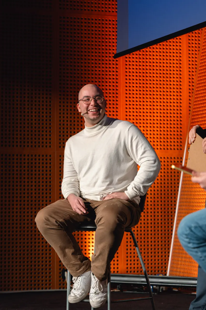 A speaker smiling on stage