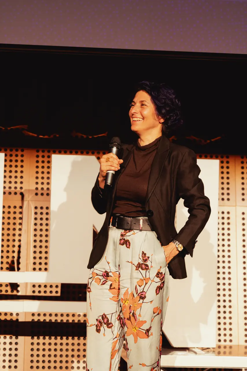 A speaker laughing at the microphone