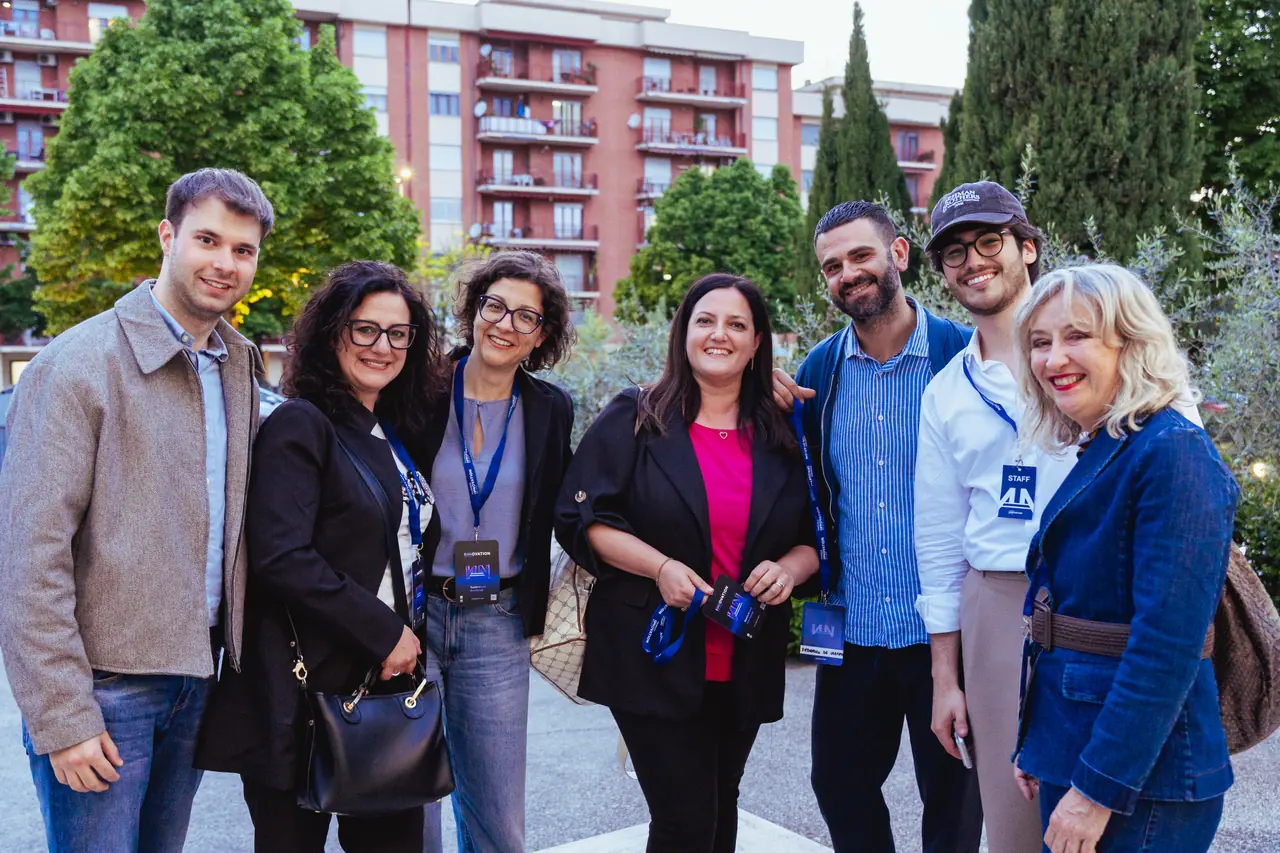 A group smiling during networking at sunset